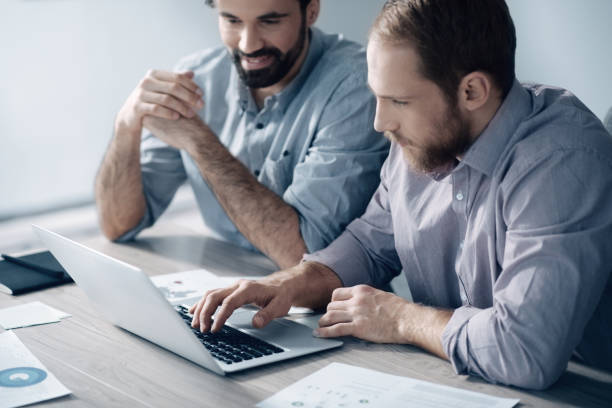 istock Concentrated professional men working together in the office 1002885776