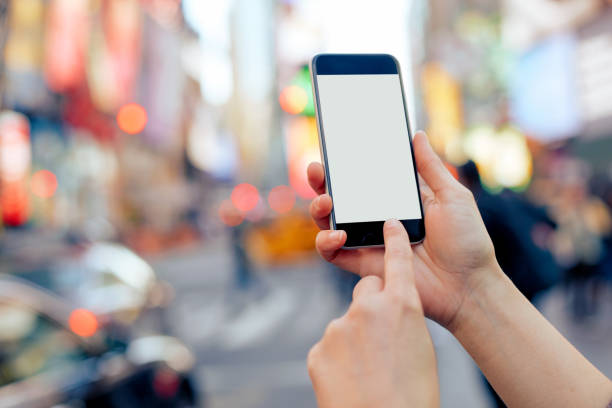 istock Woman using her smartphone in Times Square 1002888686