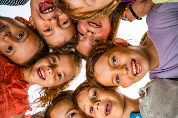 Group of cute children making circle around a camera