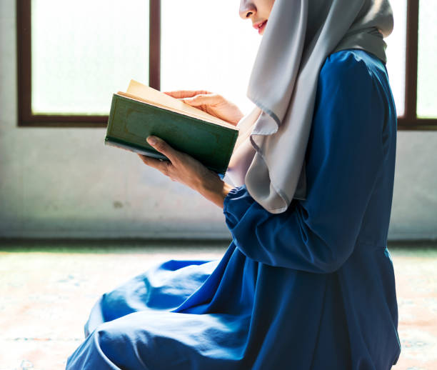 istock Muslim woman reading from the quran 1002890876