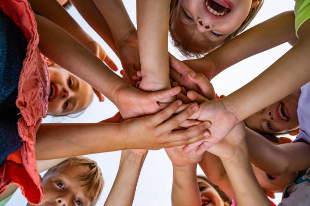 istock Happy kids holding hands in the circle 1002893034