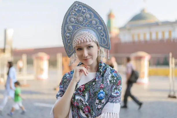 Portrait of beautiful young woman in light blue kokoshnik.