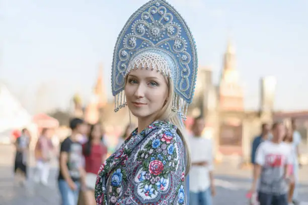 Portrait of beautiful young woman in light blue kokoshnik.