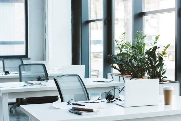 istock headsets and laptops on tables in modern office 1002899286