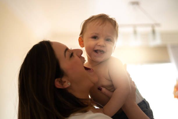 istock Mother Picking up your baby at Home 1002901678