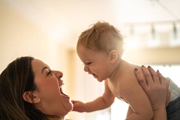 istock Mother Picking up your baby at Home 1002901680