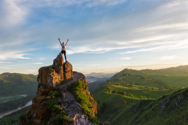 istock Happy woman on top mountain 1002902320