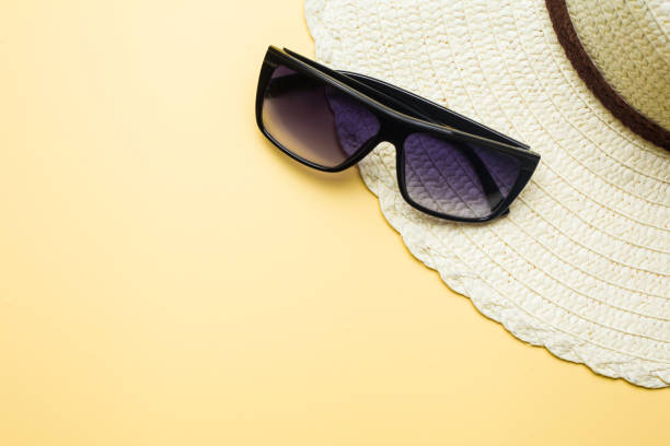 istock Summer concept, hat and glasses on a yellow background, vacation at sea 1002905680
