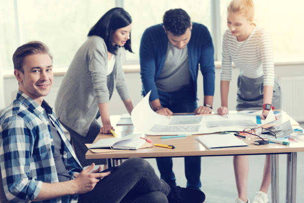 istock Handsome blonde sitting in semi position in office 1002914636