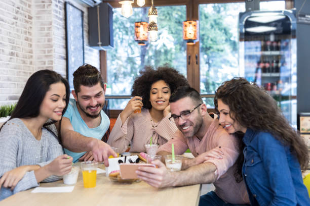 istock Coworkers enjoying time together in cafe 1002917698