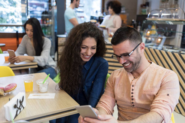 istock Couple in love having fun and using smart phone 1002917710