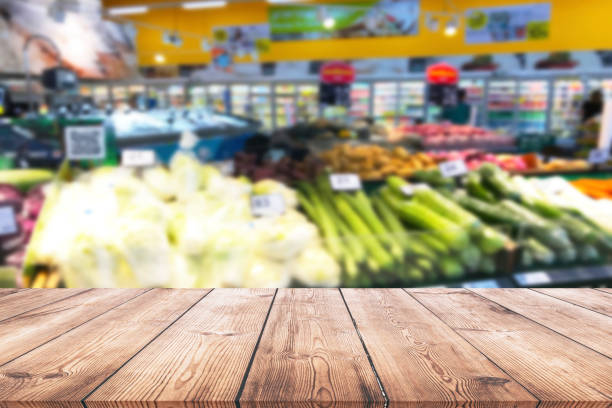 istock Empty wood table top on shelf in supermarket blurred background 1002918206