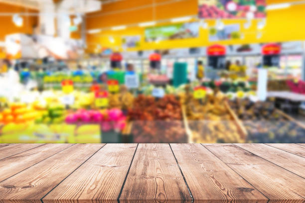 istock Empty wood table top on shelf in supermarket blurred background 1002918226
