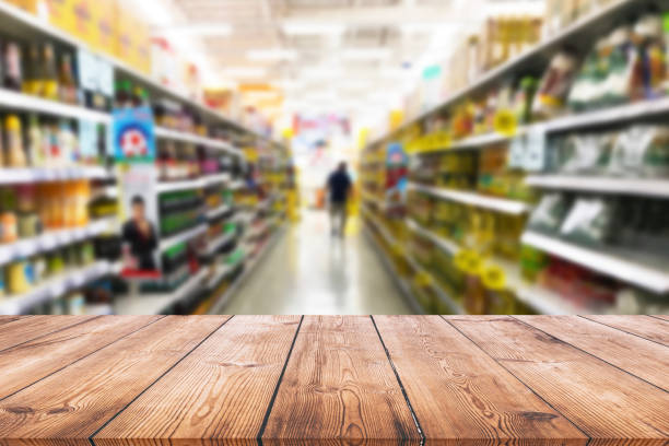 istock Empty wood table top on shelf in supermarket blurred background 1002918316