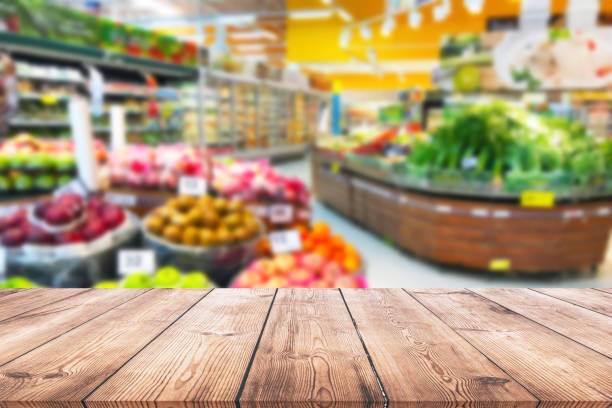Empty wood table top on shelf in supermarket blurred background