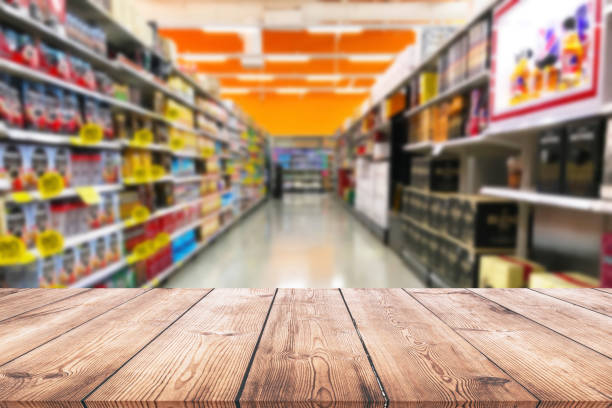 istock Empty wood table top on shelf in supermarket blurred background 1002918328