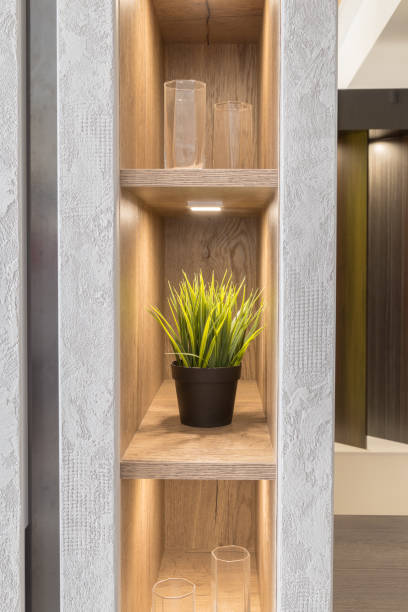 istock Artificial flower on the shelf in the closet with a new design and lighting 1002921326