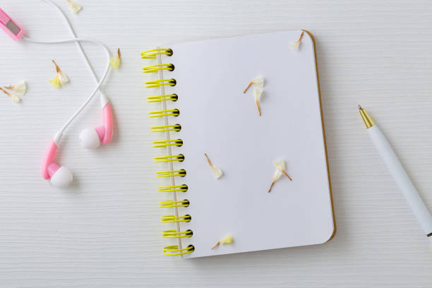 istock Earphones and notebook with flower 1002921514