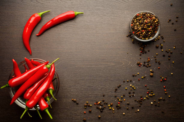 istock bunch fresh raw red hot chilli pepper and bell pepper on a woode 1002922810
