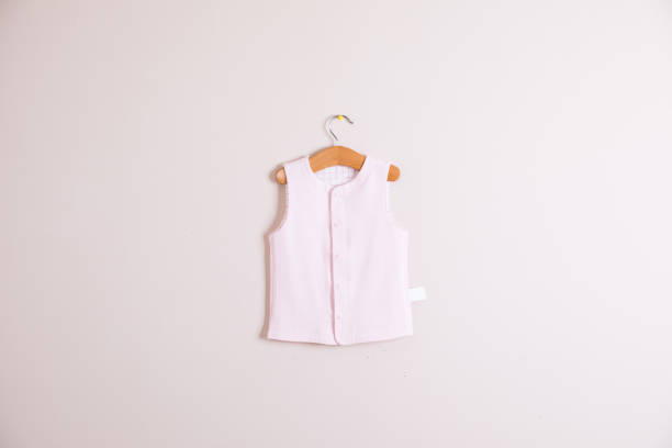 istock Baby clothes and accessories on wooden background 1002925104