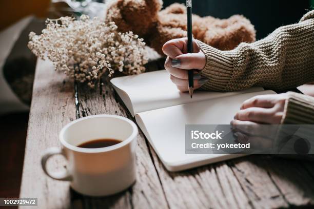 Close Up Of Womans Hands Writing On Book Vintage Color Tone Stock Photo - Download Image Now