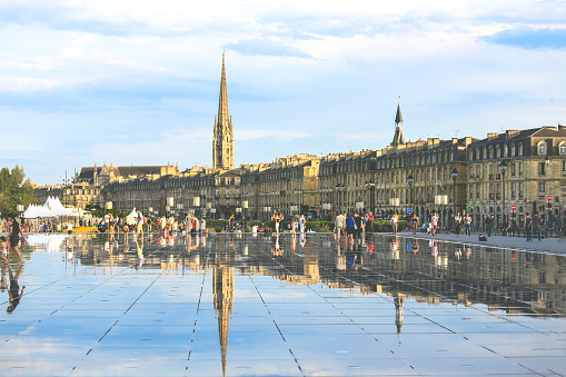 BORDEAUX, FRANCE - 17 May, 2015 : Bordeaux water mirror full of people in one of the hotest summer day, having fun in the water, the pool is the largest water mirror in the world with 3450 sq.m.