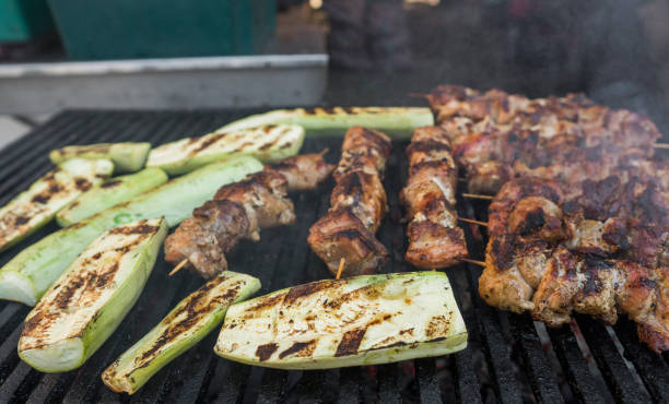 istock Zucchini and meat shish cooking on a grill. 1002945138