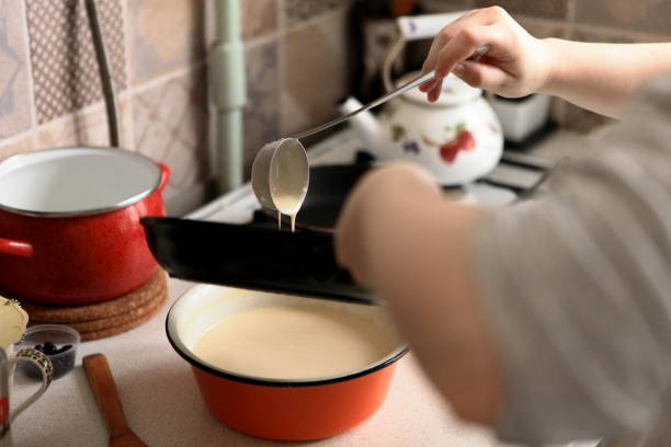 istock Making Pancakes on frying pan. Making Crepes on frying pan. 1002975854