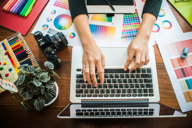 istock Professional Asian women working with colour samples for selection. Architectural drawing with work tools and accessories. 1002986762