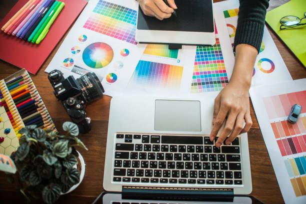 istock Professional Asian women working with colour samples for selection. Architectural drawing with work tools and accessories. 1002986768