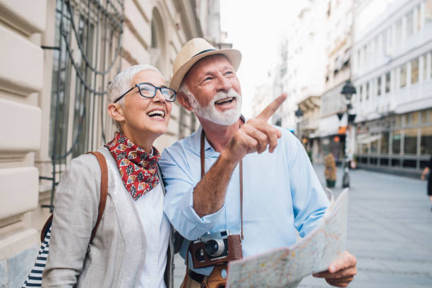 istock Elderly couple of tourists 1002989112