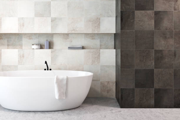 istock White bathtub in a tiled bathroom 1002992548