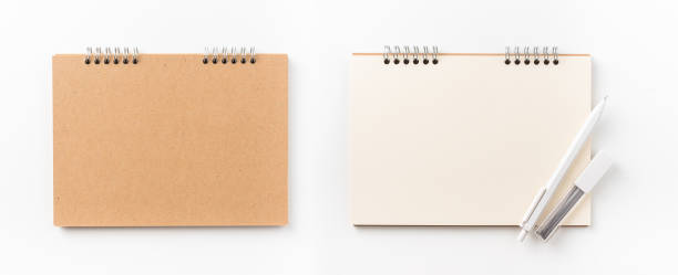 istock Top view of kraft spiral notebook, blank page and wood pen 1002996258