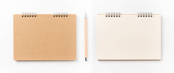 istock Top view of kraft spiral notebook, blank page and wood pen 1002996452