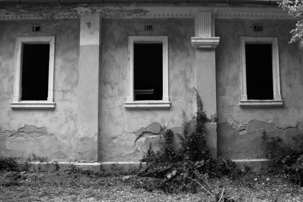 istock Three windows in an abandoned building in black and white 1002996482