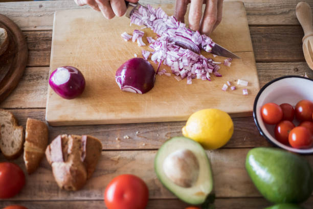 istock Home cooking, making a sandwich, onion chopping, close-up 1002999404