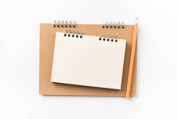 istock Top view of two kraft spiral notebook, blank page, mechanical pencil 1002999860