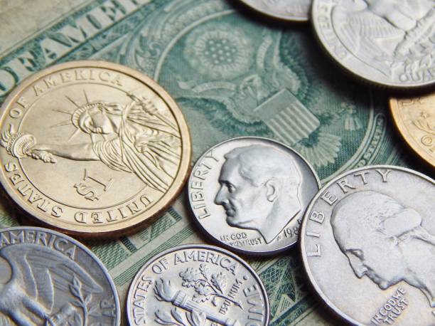 istock paper dollar with US coins 1003000872