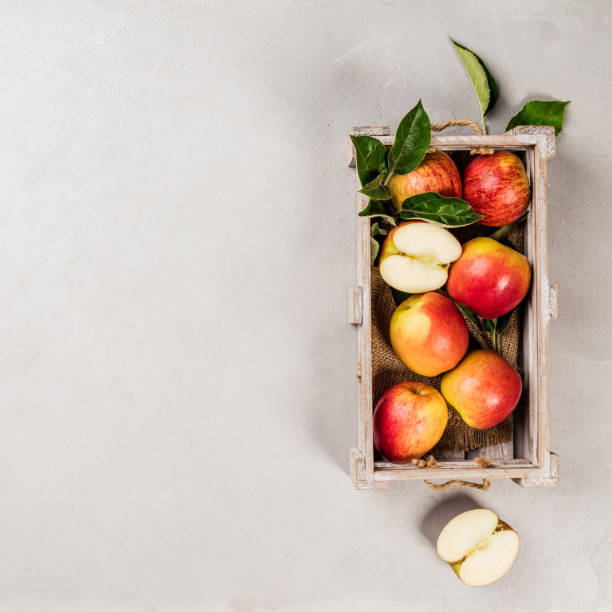 istock Ripe organic apples in wooden tray 1003012514