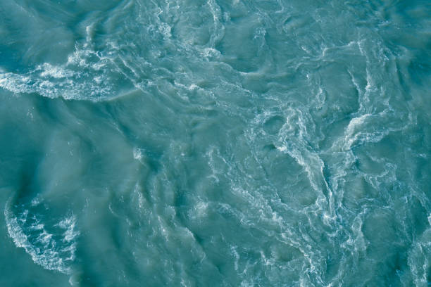 istock Abstract blue sea water with white foam for background 1003014032