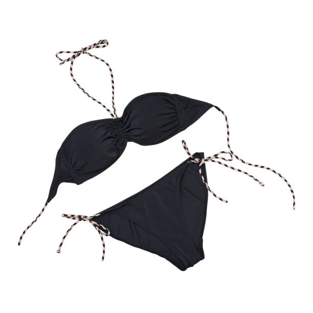 istock Black swimsuit on a white background. Isolate. Beach wardrobe. Fashionable concept 1003016152