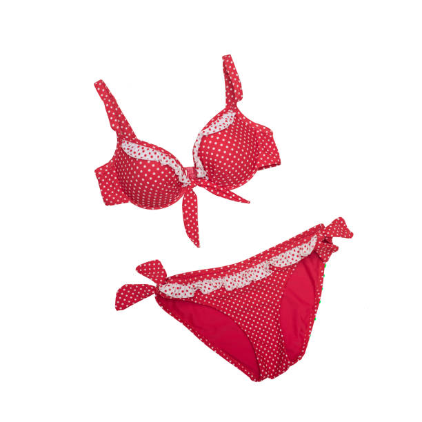 istock Red polka dots swimsuit on a white background. Isolate. Beach wardrobe. Fashionable concept 1003016210