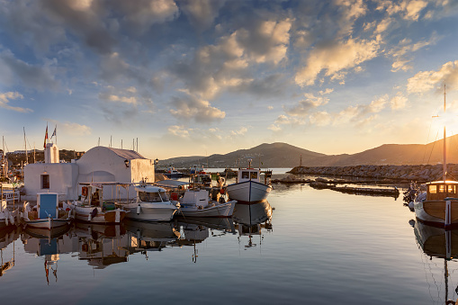 Sunset over the traditional fishing village of Naousa on Paros, Cyclades, Greece, during summer time