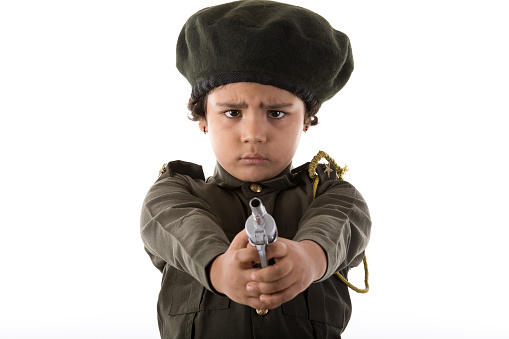 Junior policewoman shooting with a toy gun