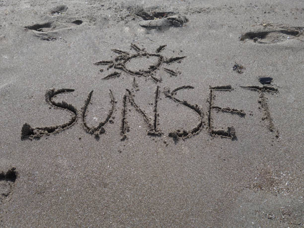 istock the sunset word is sandy on the beach 1003061234