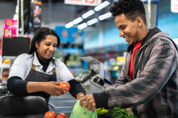 istock Customer and Cashier in checkout at Supermarket 1003064430