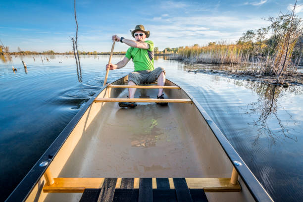 istock paddling canoe on calm lake 1003087296
