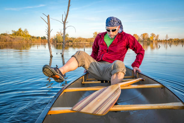 istock paddling canoe on calm lake 1003089444