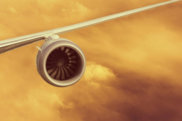 Airplane engine above  land mountains and clouds