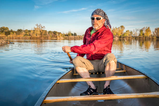istock paddling canoe on calm lake 1003089906